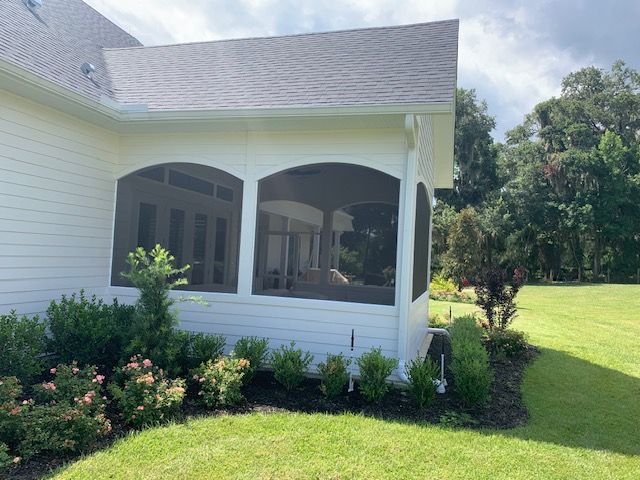 A screened porch on a white Central Florida home