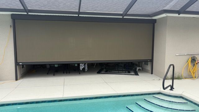A retractable screen lowered on a pool lanai